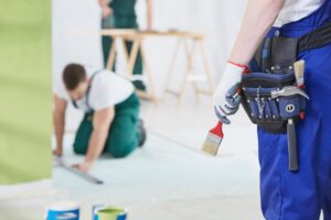 Group of specialists working by the house renovation together