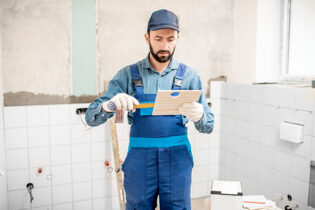 workman-putting-tiles-indoors-2021-12-09-03-19-03-utc (1)